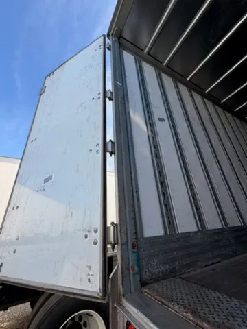 Close-up of trailer door hinges and aluminum side wall showing quality construction