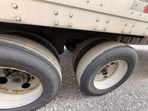 Close-up of dual rear wheels showing tire tread depth and wheel condition