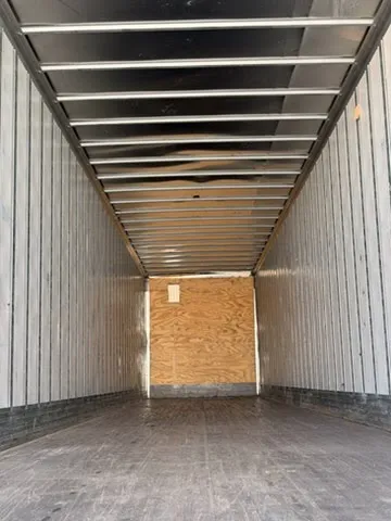 Full interior cargo area view showing clean wood floor, aluminum walls, and 53-foot length