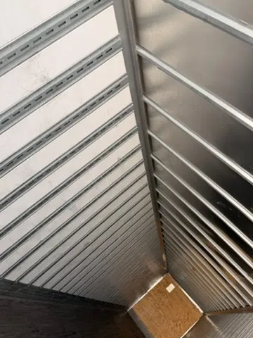 Interior view showing aluminum roof crossmembers and corrugated side walls