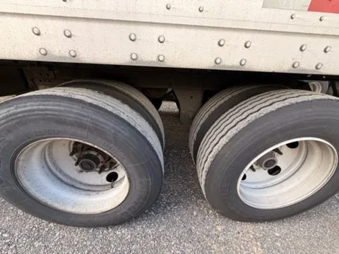 Rear tandem wheels and axle assembly showing proper tire inflation and alignment