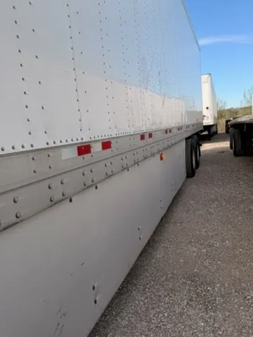 Side panel with DOT-required reflective markers and riveted aluminum construction