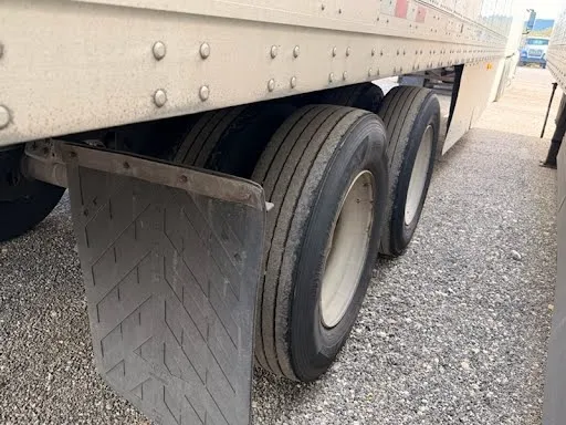 Tandem axle with commercial-grade tires and mud flaps in good condition